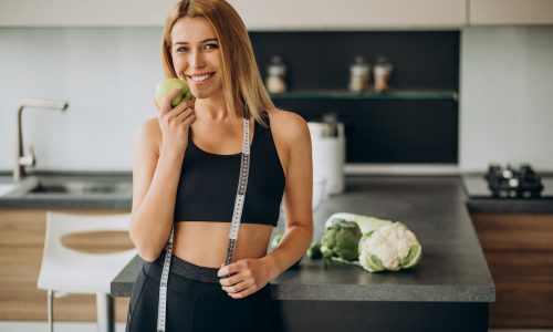 1 young woman with measuting tape kitchen